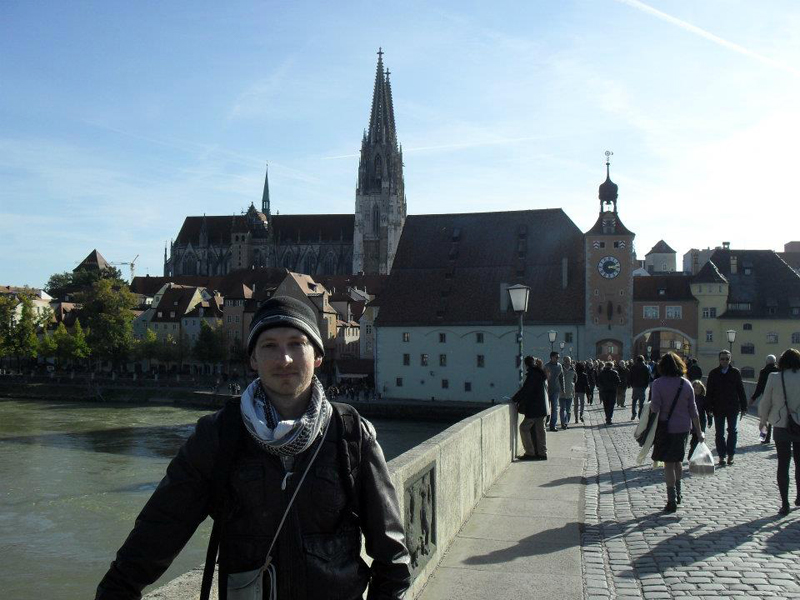Dr Chris van Rhyn on one of his travels, in front of the church in Regensburg, Germany.
